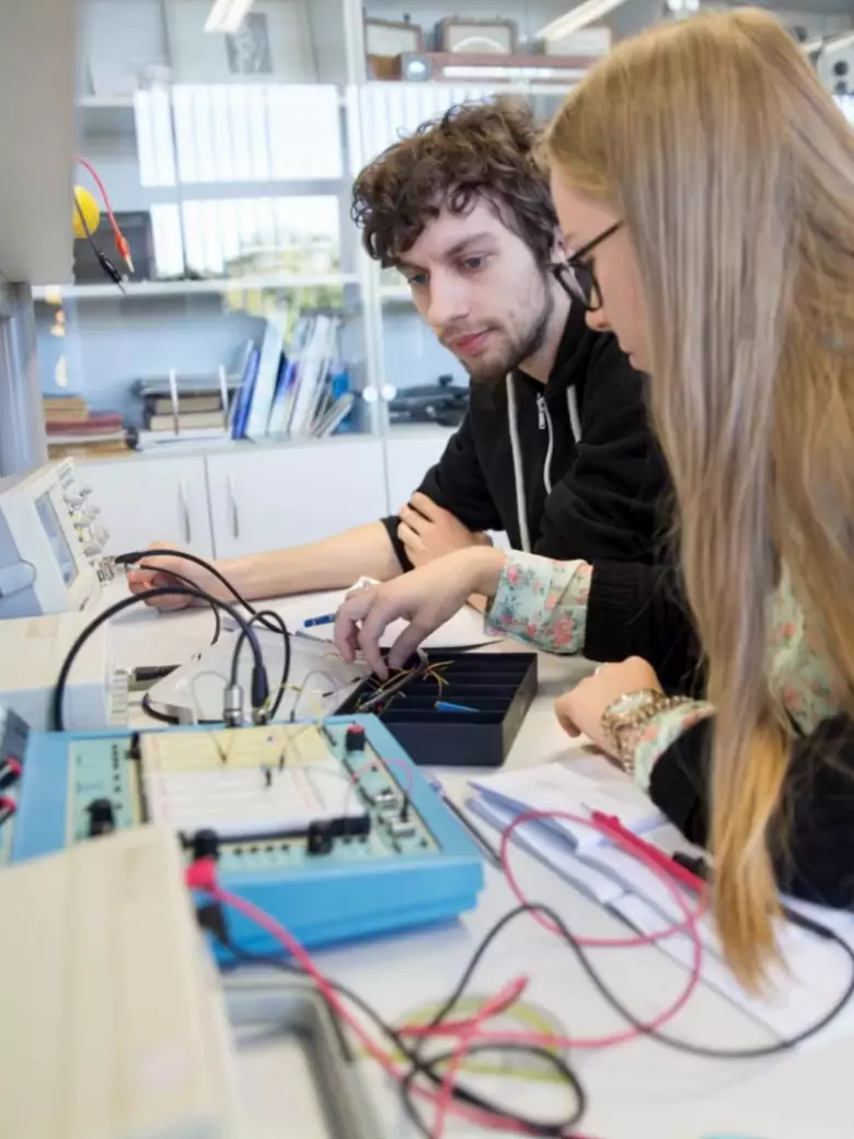 Students work with electronic components in a lab – hands-on learning where theory turns into action. KTU’s tech programs offer opportunities to experiment with real-world systems.