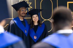 KTU international students posing in the front of a photowall during graduation