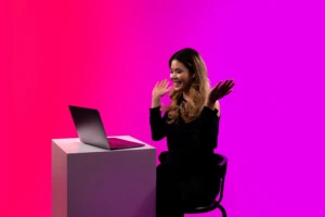 happy girls dressed in black with an open laptop